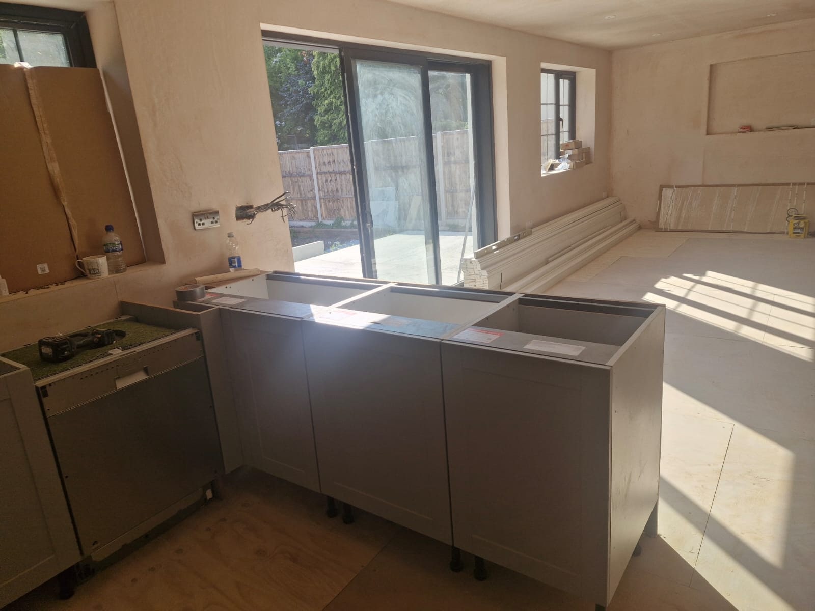 Kitchen cabinets and island units being fitted by Perfect Builder