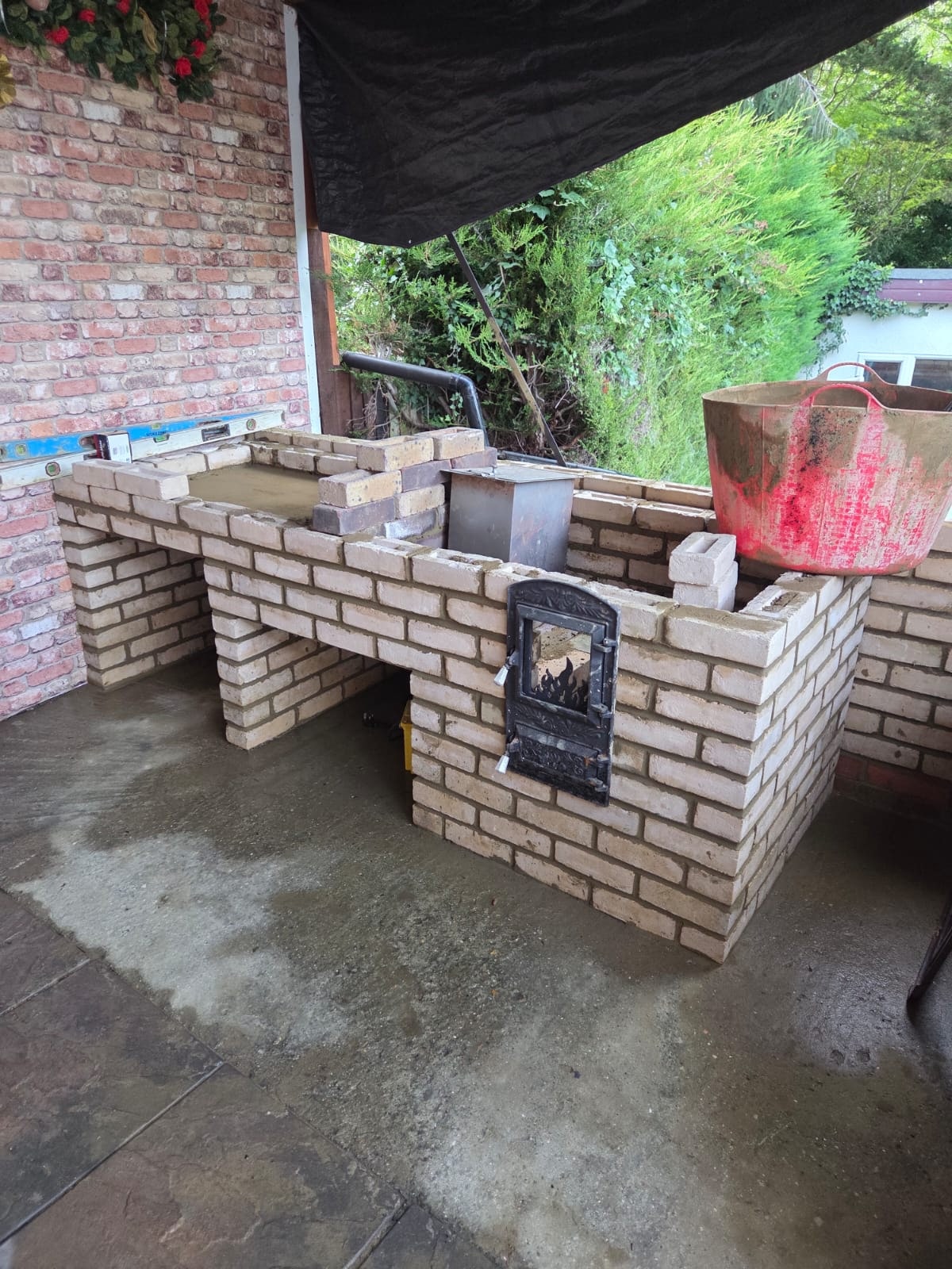 Outdoor brick BBQ structure built in a garden